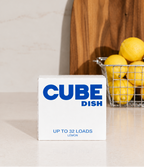 CUBE Dish Lemon dishwasher detergent cubes, up to 32 loads, next to a basket of lemons